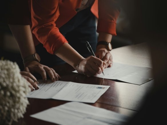 Property lawyer signing documents